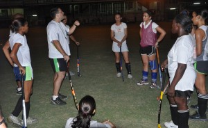 National Female Hockey Coach Philip Fernandes makes a point  to the players during a training session at the GCC ground recently. 