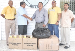 Director General of the Civil Defence Commission Col. Chabilall Ramsarup (2nd left) says thanks to President of the Guyana Amateur Powerlifting Federation Peter Green for the donation. Others in photo from right are Vickram Bhudram, GAPF PRO Mark Seymour and Committee Member Gordon Spencer. 