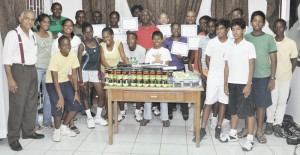 Participants of the 8-day Programme which was conducted by ITF Development Officer Anthony Jeremiah pose with their certificates along with members of the junior squad (front) and GLTA President Christopher Ram (extreme left) last Monday. 