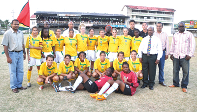 Aiming for more Glory!!! The Lady Jags & Technical staff posing with Minister of Sport  Dr. Frank Anthony (left), Minister of Agriculture Robert Persaud (2nd right back row) & GFF Boss  Colin Klass (with tie) after defeating St. Vincent & the Grenadines on March 7, 2010 at the GCC.