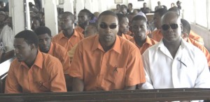 DEEP IN SORROW!!! Members of the Ravens Basketball Club and the late Kevin Lawrence’s team-mates pay their final respect to the former national forward yesterday at the St. James-The-Less Church on David Street, Kitty.