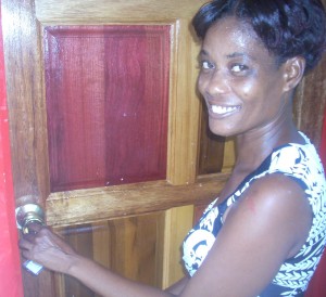 Samantha Jordan proudly  unlocks the door of her new home