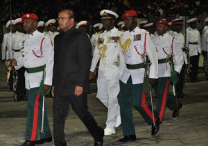  President Jagdeo is escorted en route to inspecting the ceremonial Guard of Honour last night at the National Park.