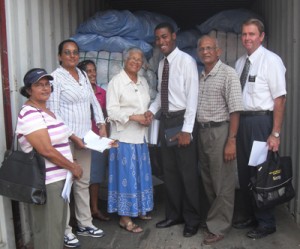 Dillion Murray shakes hands with Ms Bernice Mansell as he officially hands over the endowment yesterday. They are flanked by representatives of the Church, the Foundation and the Guyana Relief Council’s Rohini Bonar (at extreme left)