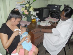  Nurse Adams-Thompson attends to a mother and her baby
