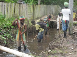 Workers from the Victory Vally CDC group clear Watanabo creek