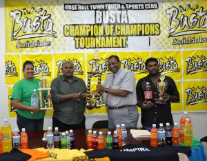 Managing Director of Guyana Beverage Company Robert Selman (2nd right) hands over the Busta Champions of Champions winner’s trophy to RHTY&SC, PRO Munesh Singh, at left is GBC Customer Service Representative Shameiza Yadram and right Ravi Narine a first division player. 