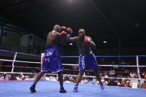 Despite his high gaurd, Leon Gilkes  (left) gets his defence breached by a  searching jab from Anthony Augustin