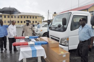 Minister of Home Affairs Clement Rohee and Police Commissioner  Henry Greene inspect equipment for the new vehicles the Police received yesterday. 