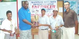 Chief Executive Officer of Safeway Security Eon Caesar (second left) presents the winning trophy to Avinda Kishore in the presence of Boloram Deo, Mike Mangal and Lester Alvis.