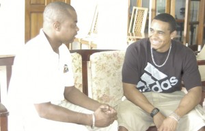 Guyana’s US-born sprint Olympian, Adam Harris (right) talks with Kaieteur Sport journalist, Edison Jefford at Olympic House yesterday; it was the first visit to Guyana for the sprinter and his first local interview since making his national debut at the Olympic Games in 2008.