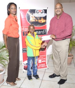Demerara Mutual’s, Mr. Clarence Perry, presents the cheque to Leon Seaton. At left is GASA’s Secretary Dee George.