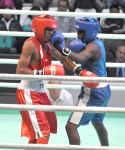 Tefon Greene (right) lands a solid left punch on the button against A. Zarraga of Venezuela.