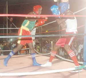 Bert Braithwaite (left) .goes on the attack against Kelon King in a Junior Welterweight fight of the Mackeson Fight Night in Linden.