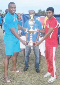 The two captains jointly receiving the winning trophy from Larry Wills, Brands Executive of DDL.  