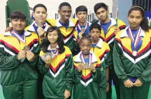 The members of the fourth placed Guyana badminton team display their medals following the presentation of the Caribbean championships in Puerto Rico.