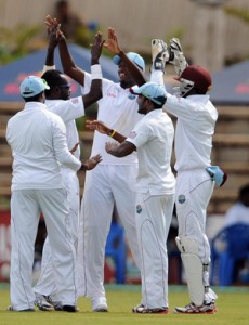 West Indies A players congratulate Nikita Miller (2nd left) on his match winning 9 wicket haul in India. (BCCI)