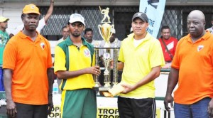 Joint winners, captain of the Regal XI Mohamed Ayube (left) and Wolf Warriors skipper Amit Rai display the first place trophy in the presence of GSCL’s Lance Hinds (left) and Ian John.