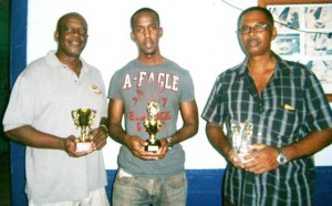 Leon Belony is flanked by Orlando Michael to his right and  Devraj Deonarine, moments after the championship ended.