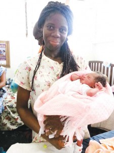  Caption: Coretta Sharpe poses with her newborn