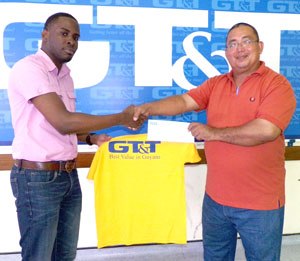 GT&T’s Quinsbert Tyndall (left) hands over one of the jerseys and cheque to GRFU’s Peter Green
