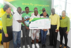 Fly Jamaica representatives with winners including Raphael and father.