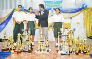 Attorney General, Anil Nandlall interacts with the top three performers  of the Anna Regina Multilateral Secondary School for 2013.