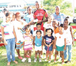 Mrs. Humphrey presenting Marlon Williams with his prize surrounded by some of her grand children.