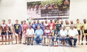 Awardees from the 2013 five-stage Road Race with Sport Minister Dr Frank Anthony and director of Sport Neil Kumar. Champion Raynauth Jeffery is seated with his trophy. 