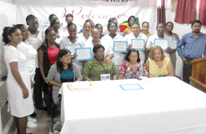 From left (sitting) Programme Instructor Zairool Ally, Senior Departmental Supervisor June Cato and Vice President Pamela Harakh are flanked by officials and the certified nurses.  