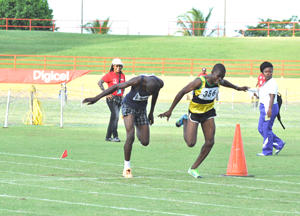 TIGHT! West Demerara’s, Rondel Austin (right) grimaces as he out-leans Corentyne’s, Denzil Leitch to win the 800m Boys Under-20 race yesterday at the National Stadium.