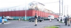 Heavily armed police ranks surround the prison during yesterday’s unrest.