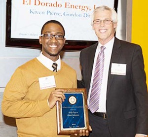 Kiven Pierre (left) receives an award from  Terry Brown, Director of the Falcone Center for Entrepreneurship, during the Panasci Business Plan Competition.