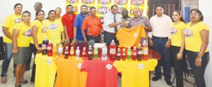 Flashback- The launching of the ECB\Busta Festival at the Guyana Beverage Company in 2013. Here, the Managing Director of the entity Robert Selman (with tie) presents  a  team jersey to president of the ECB Fizul Bacchus in the presence of other officials of the board and staff of the company. 