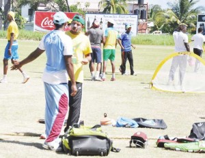 Ronnie Sarwan makes a point to Shiv Chanderpaul at a recent training session.   
