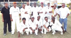 Members of the victorious Tigers team display their trophy. Standing far right is Raj Singh while secretary of the Guyana Cricket Board Anand Sanasie is at extreme left. 