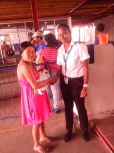  Francis holds her baby boy (left) in the company of Air Services representative Acklema Singh
