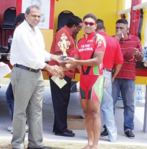 Alanzo Greaves receiving his prize from Minister Anthony.