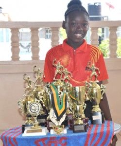 The young table tennis star poses with some of her hardware yesterday 