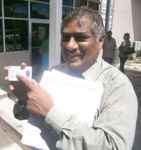  GRA’s Commissioner-General Khurshid Sattaur posing with his automated driver’s licence  