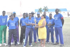 We are the champions! Qualafon Guyana Captain Kelon Carmichael receives the Noble House Seafoods Trophy from MSC’s Teresa Pemberton as his team share the moment. 
