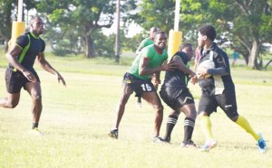 Action in the clash between University of Guyana and the Guyana Defence Force yesterday at the National Park. 