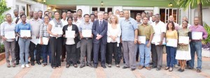 Robert Cochrane, IDB Country representative Sophie Makonnen and Junior Minister of Finance Juan Edghill with the participants of the training seminar.