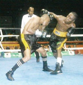 Marques holds a high left hand guard as he ducks under Hedges’ over hand right 