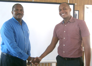  Former President Clinton Urling (right) shakes hands with the new President of the GCCI, Lance Hinds 