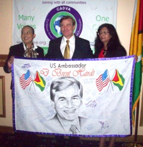U.S. Ambassador Brent Hardt poses with Secretary of the Board of Trustees of SASOD Zenita Nicholson (left) and CADVA official, Diane Madray