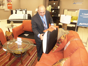 Ashley’s International Marketing Specialist, Jesus Dacal, explaining the special aspects of Ashley furnishing while showing invitees the superior quality of the product. 