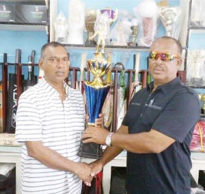 Ramesh Sunich, Managing Director of Trophy Stall hands over winning trophy to Hubern Evans, Second Vice President, BCB.