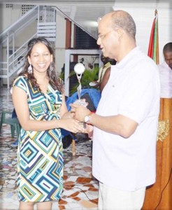 A member of the Guyana-Cuba Friendship Association presents Minister of Home Affairs and General Secretary of the People’s Progressive Party (PPP) Clement Rohee with a token of appreciation