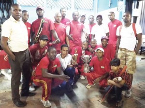 Members of the victorious Gafoor and Sons XI display their prizes. Standing far left is Banks DIH Sports Club manager Christopher Hopkinson.  